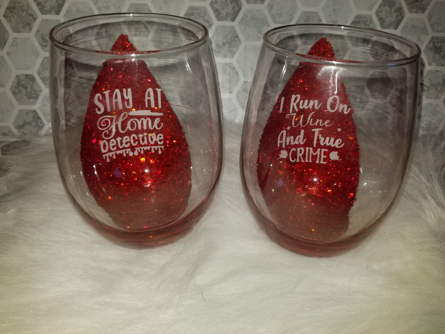 Set of 2-stemless wine glasses run on wine & true crime and stay at home detective quotes.